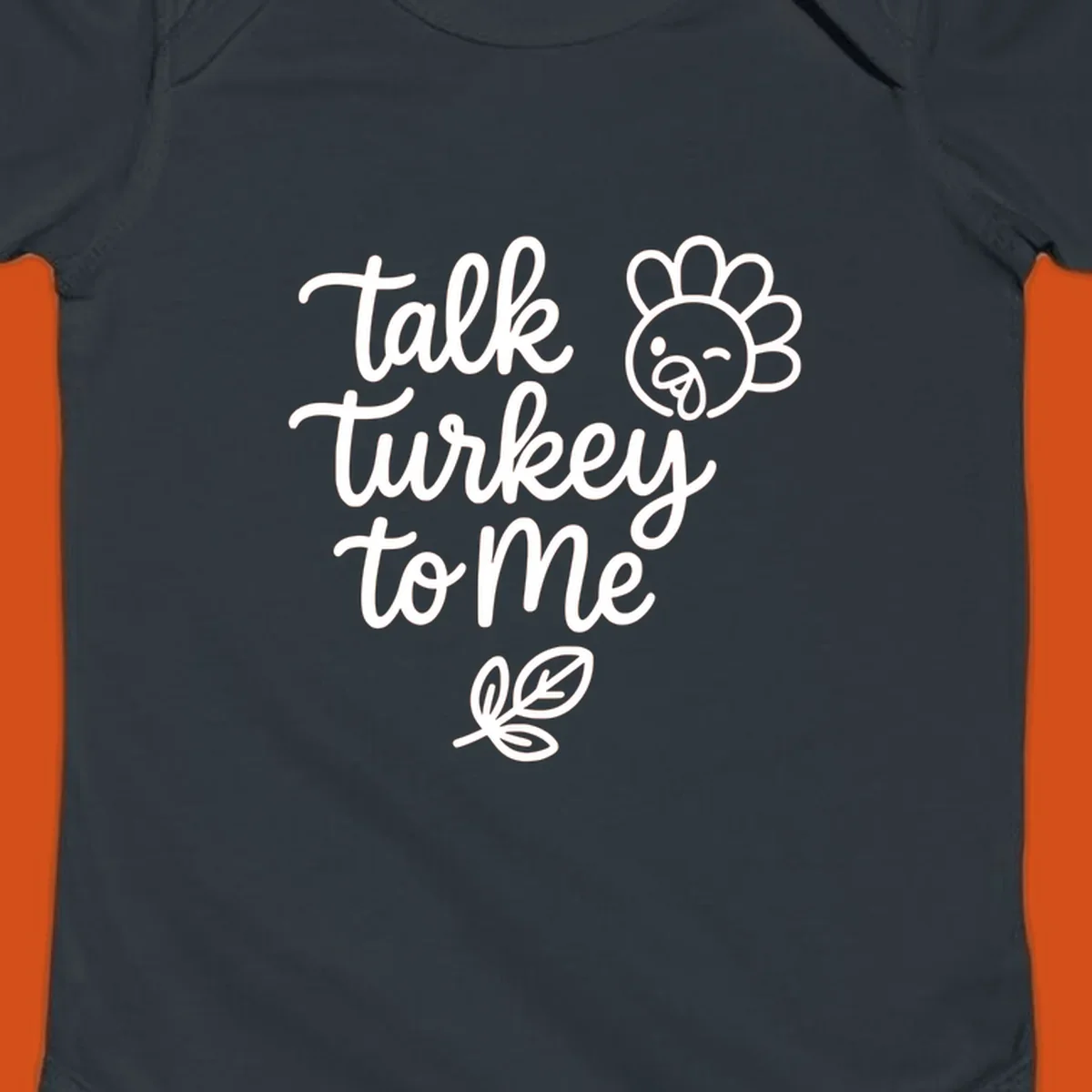 Talk Turkey To Me Thanksgiving phrase with cartoon turkey and leaf illustration.