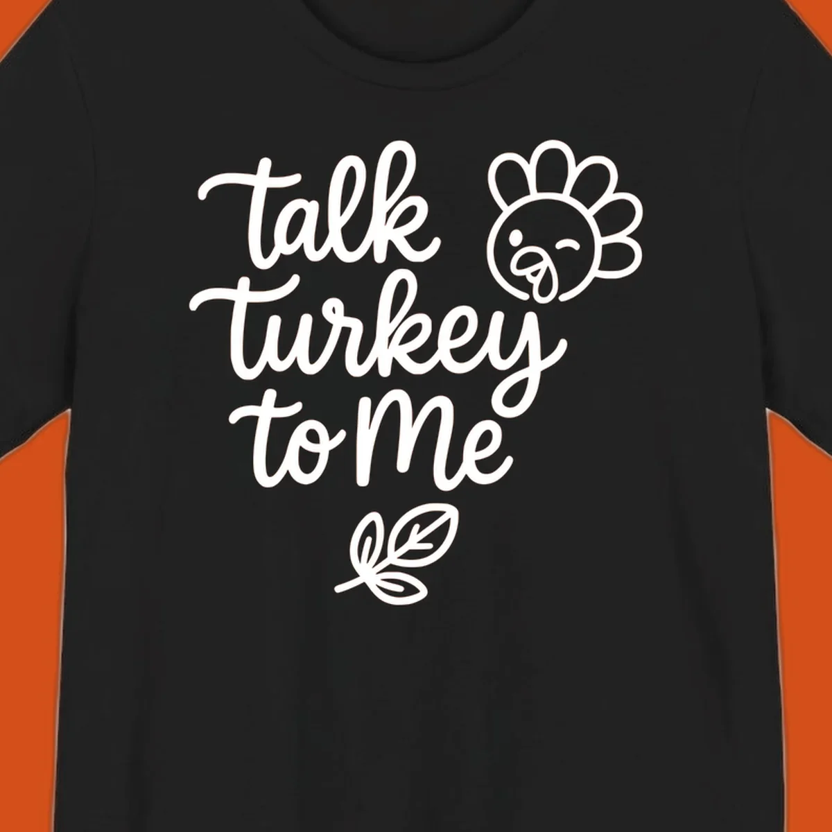 Talk Turkey To Me Thanksgiving phrase with cartoon turkey and leaf illustration.