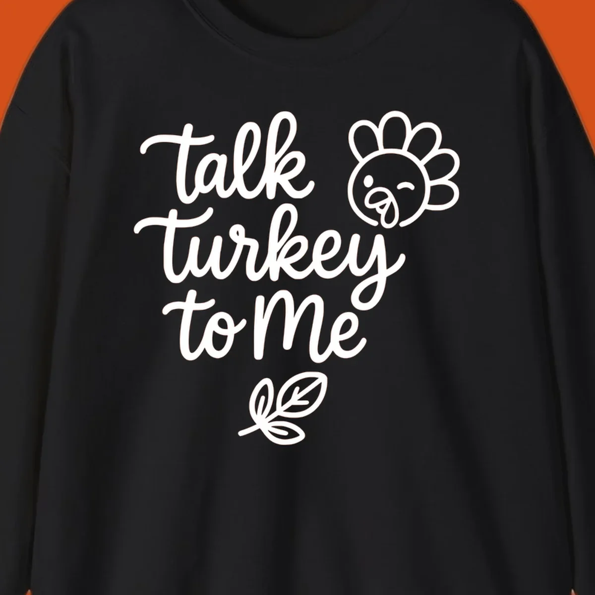 Talk Turkey To Me Thanksgiving phrase with cartoon turkey and leaf illustration.