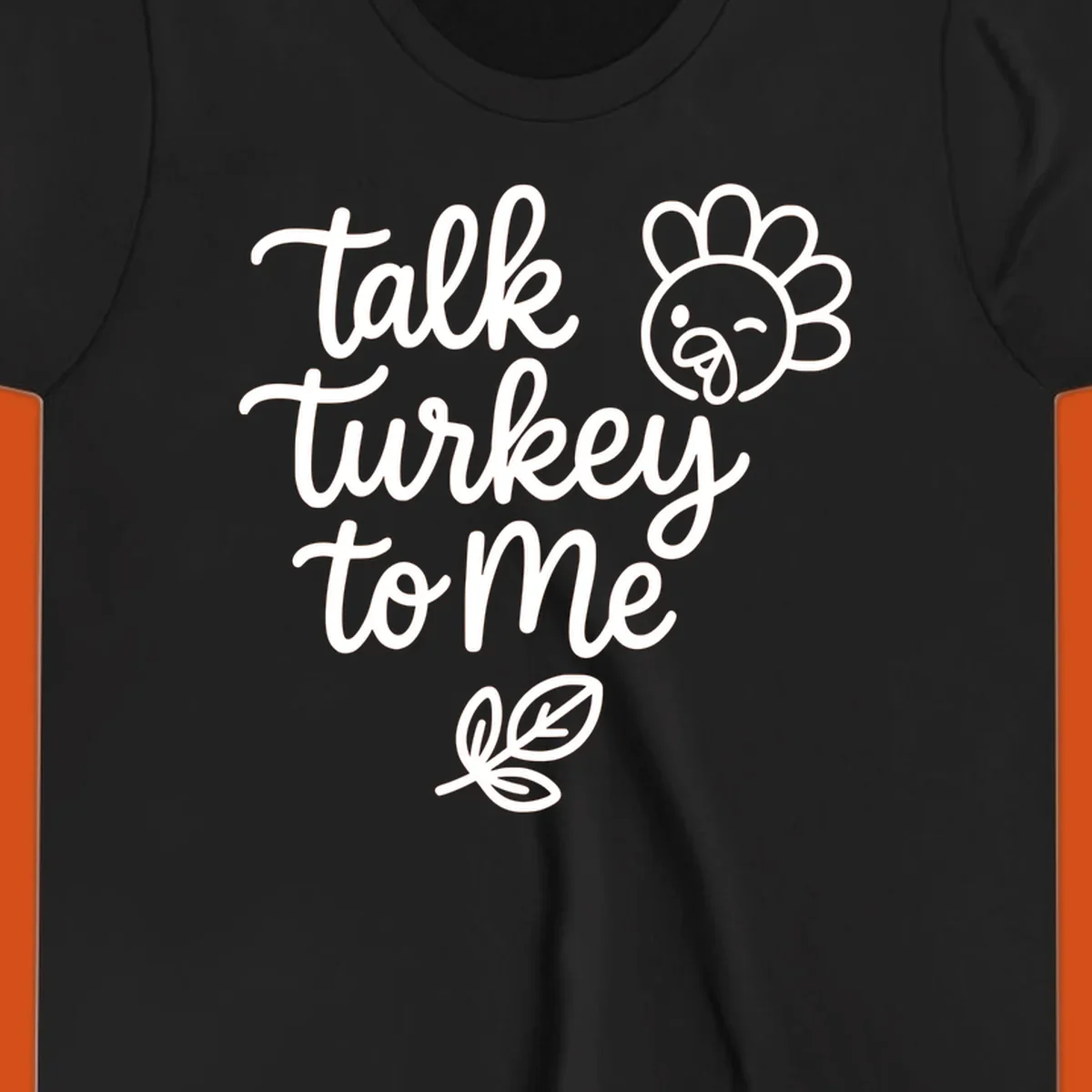 Talk Turkey To Me Thanksgiving phrase with cartoon turkey and leaf illustration.