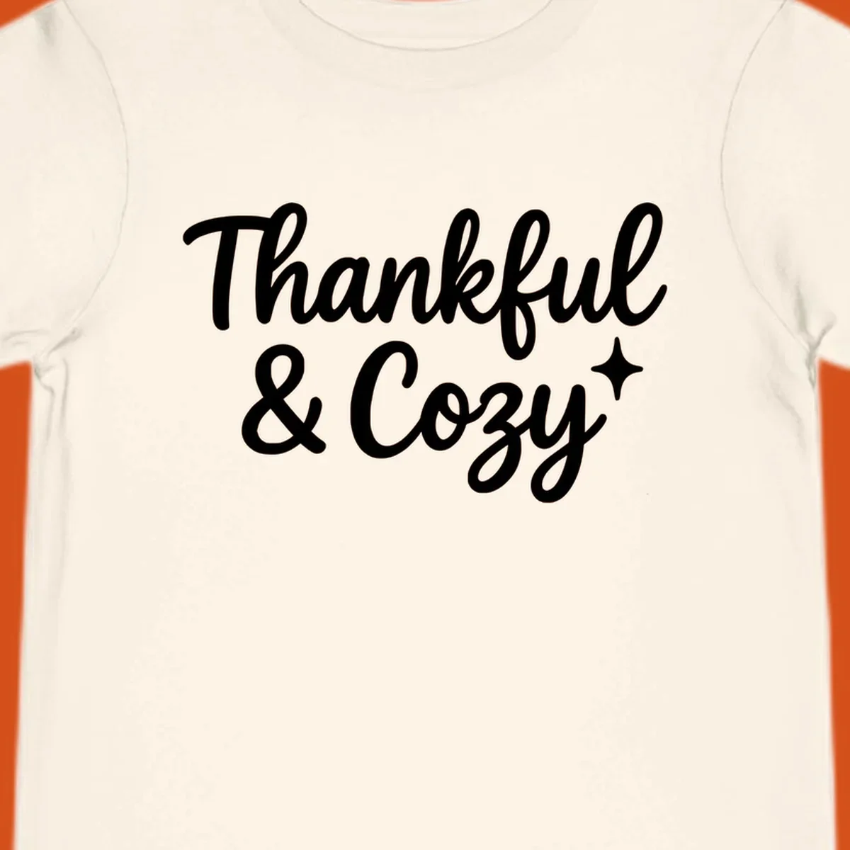 Thankful and cozy script text with starburst design.