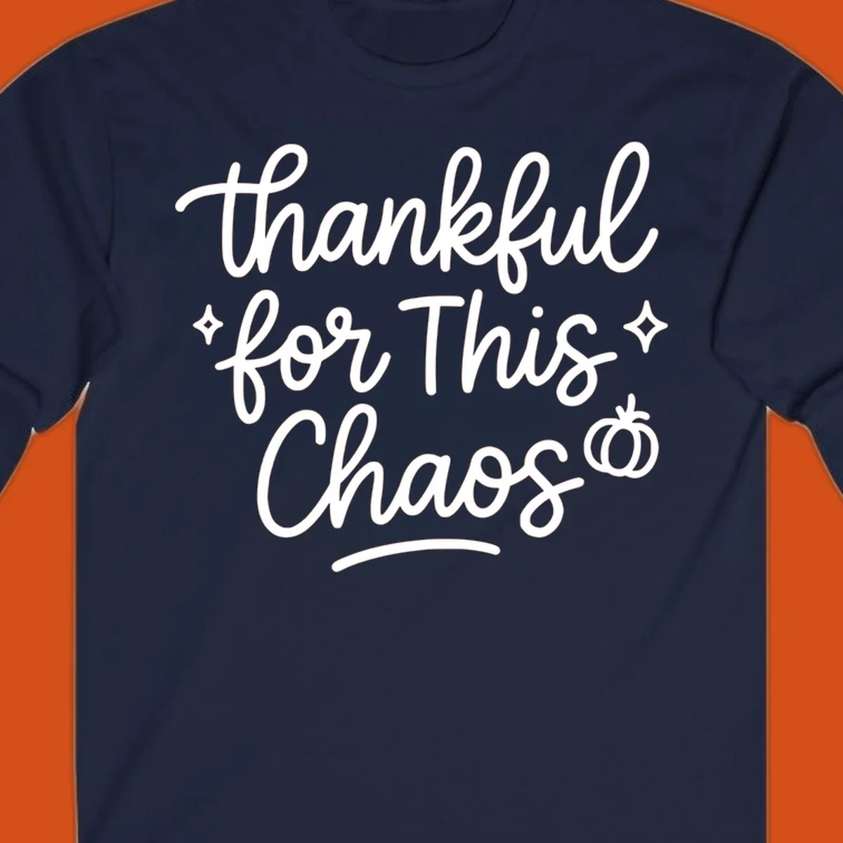 White script text 'thankful for This Chaos' with sparkles and a pumpkin on a black background.