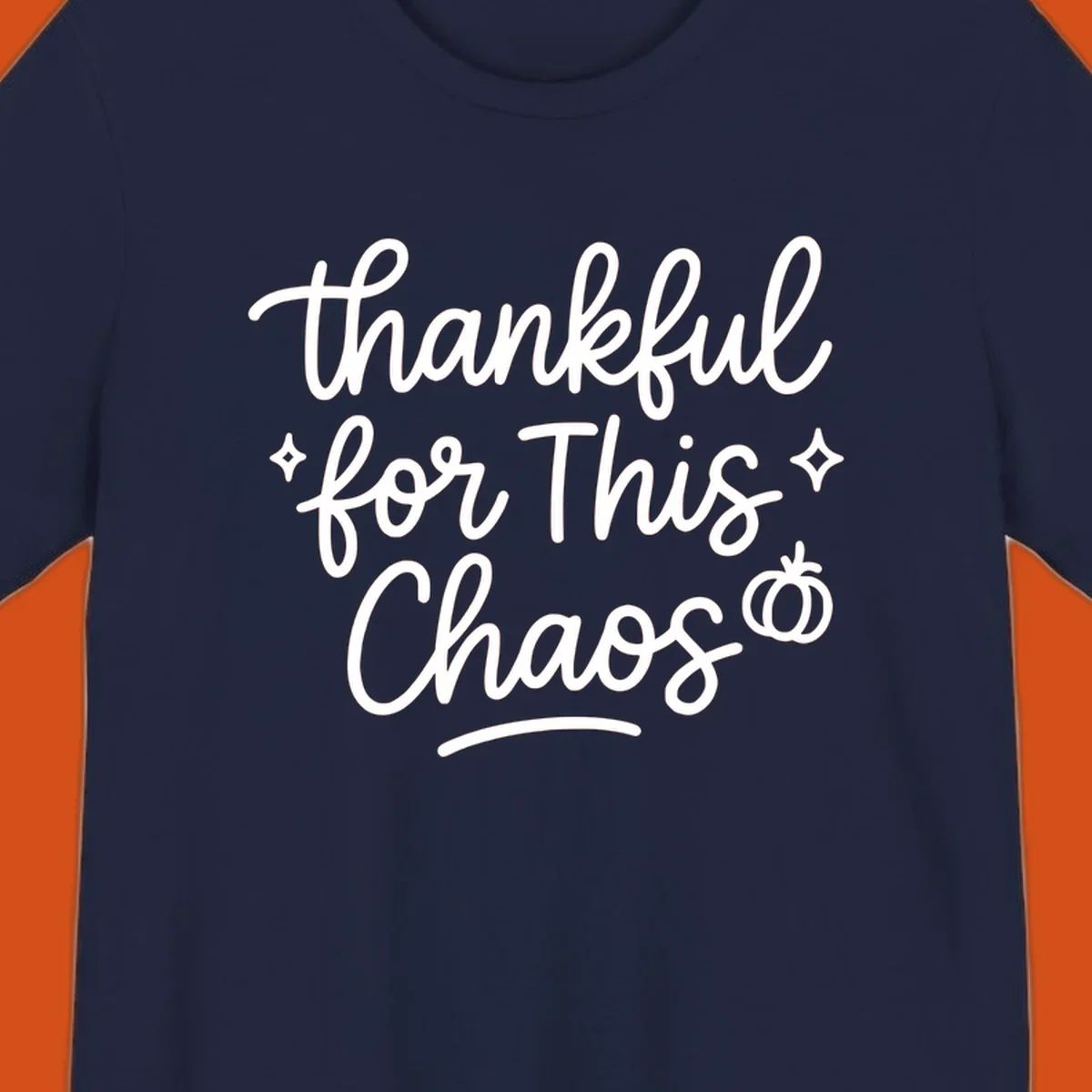 White script text 'thankful for This Chaos' with sparkles and a pumpkin on a black background.
