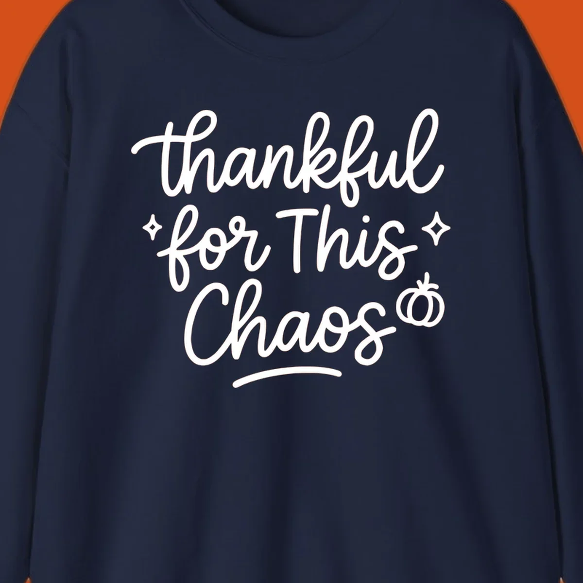 White script text 'thankful for This Chaos' with sparkles and a pumpkin on a black background.