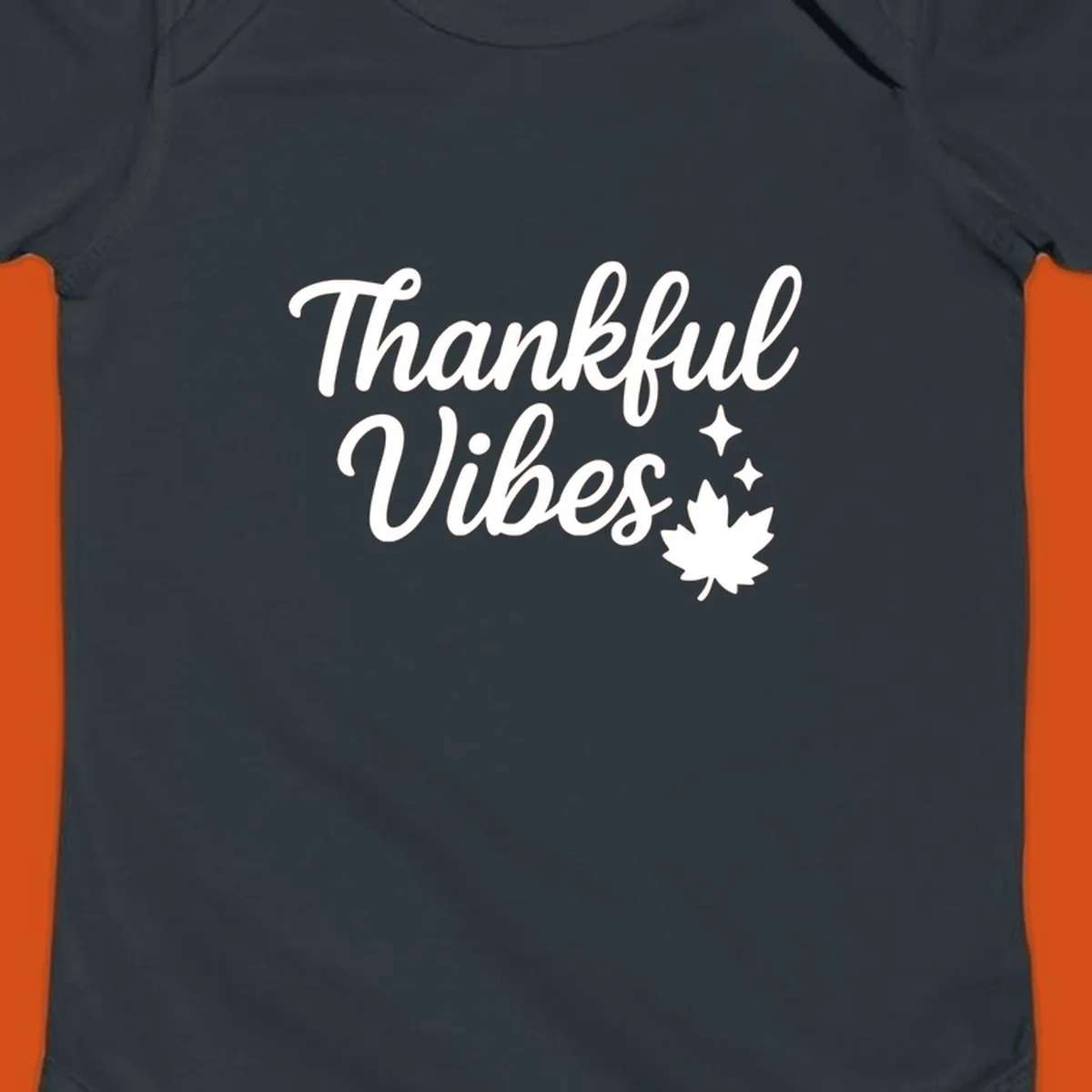 Thankful Vibes text with fall maple leaf and sparkles graphic.