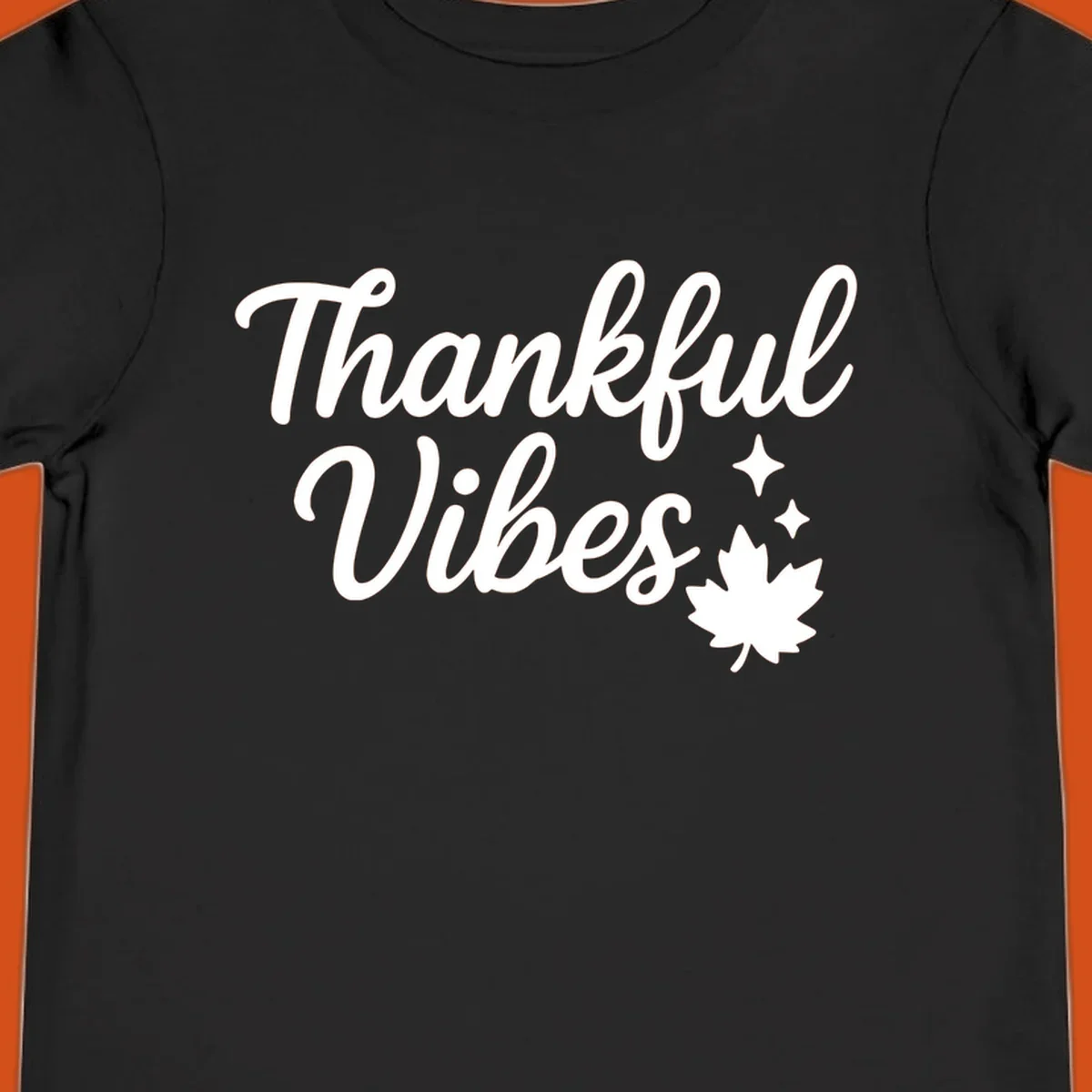 Thankful Vibes text with fall maple leaf and sparkles graphic.