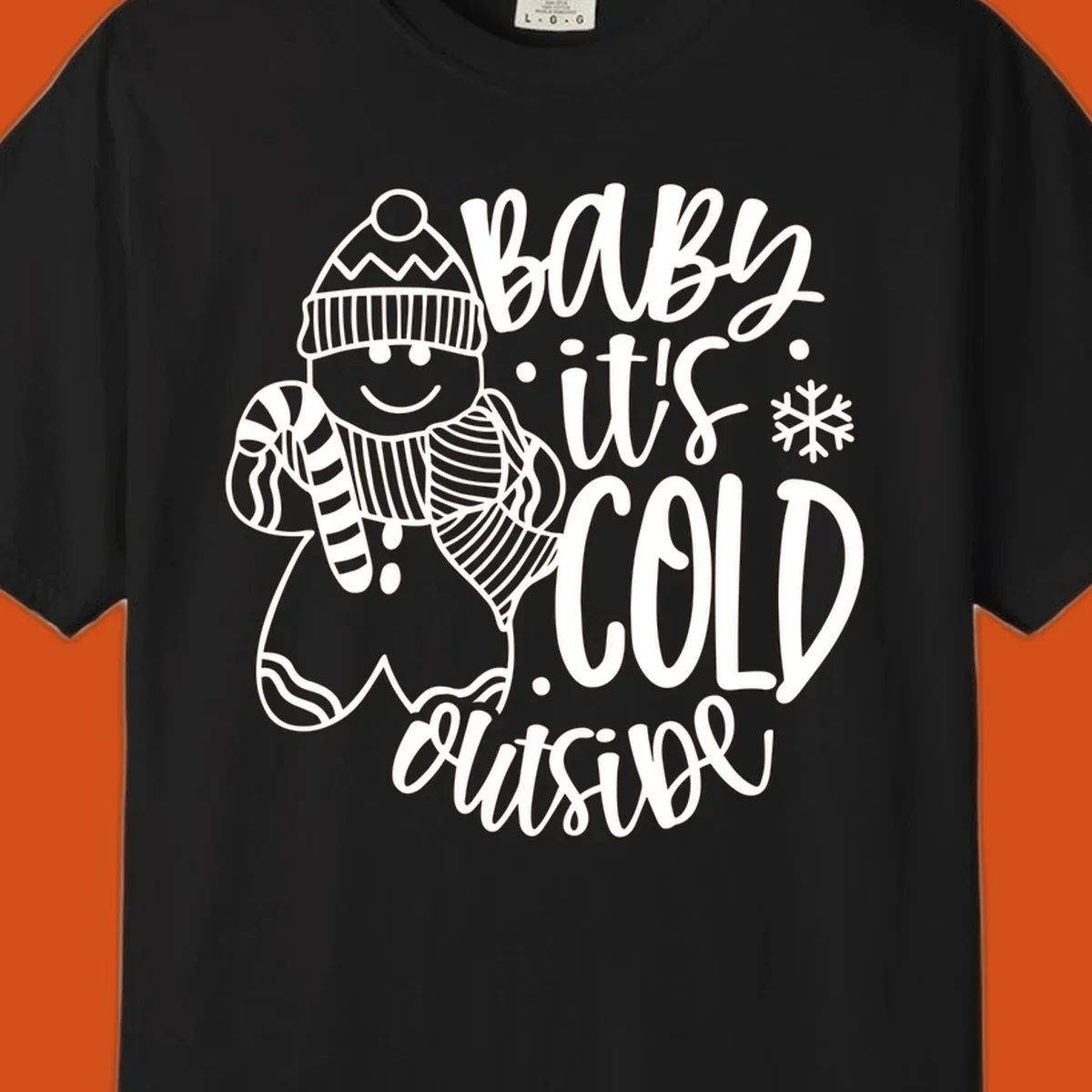 Baby it's cold outside gingerbread man with snowflake graphic.