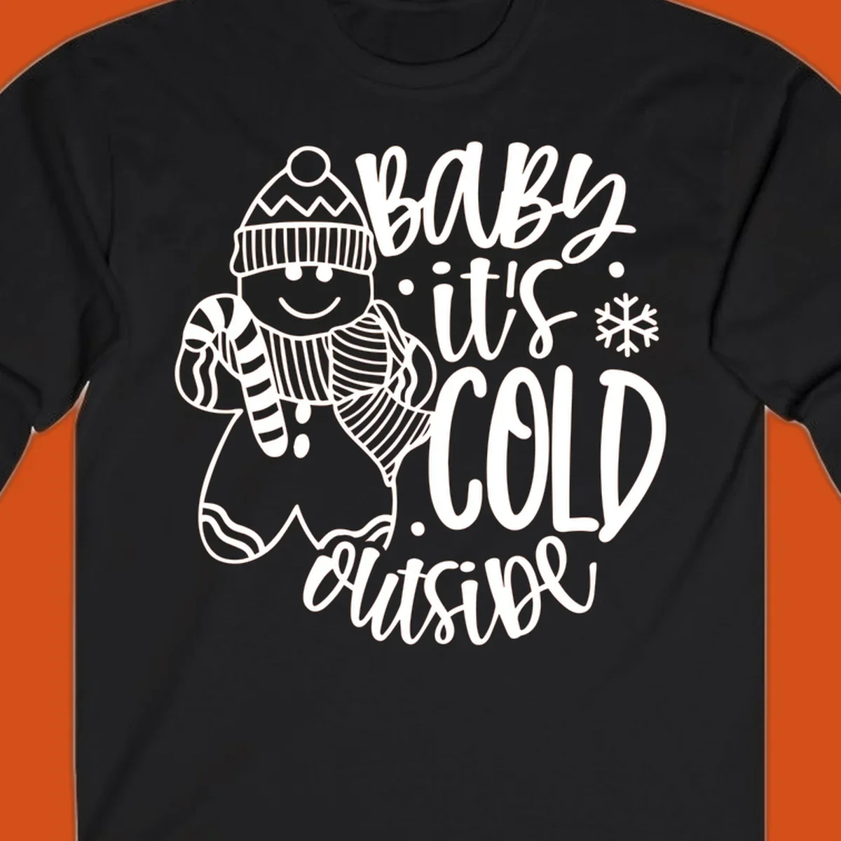 Baby it's cold outside gingerbread man with snowflake graphic.