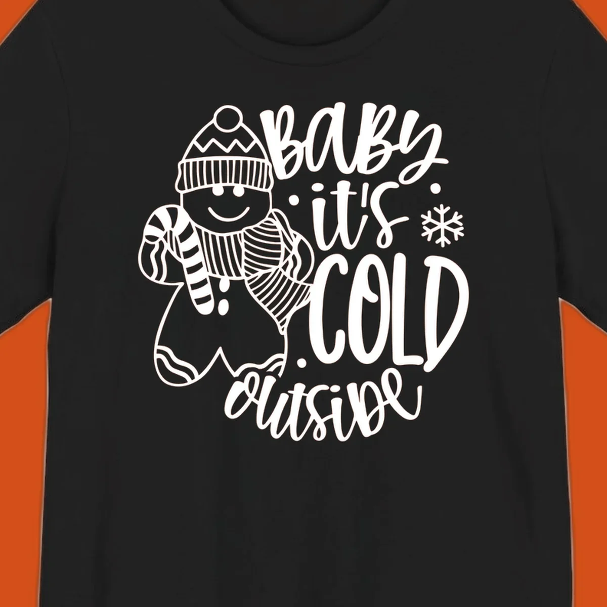 Baby it's cold outside gingerbread man with snowflake graphic.