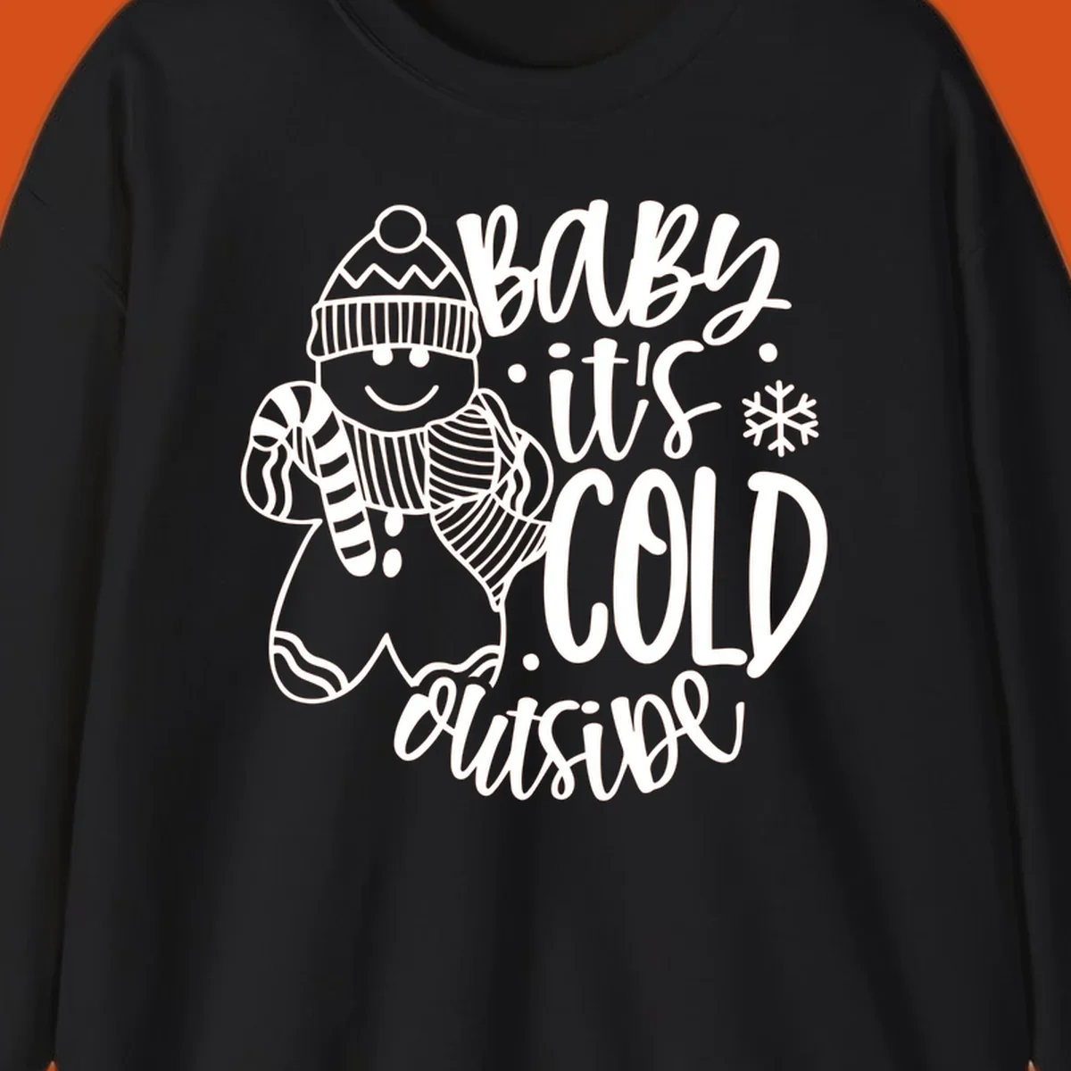 Baby it's cold outside gingerbread man with snowflake graphic.