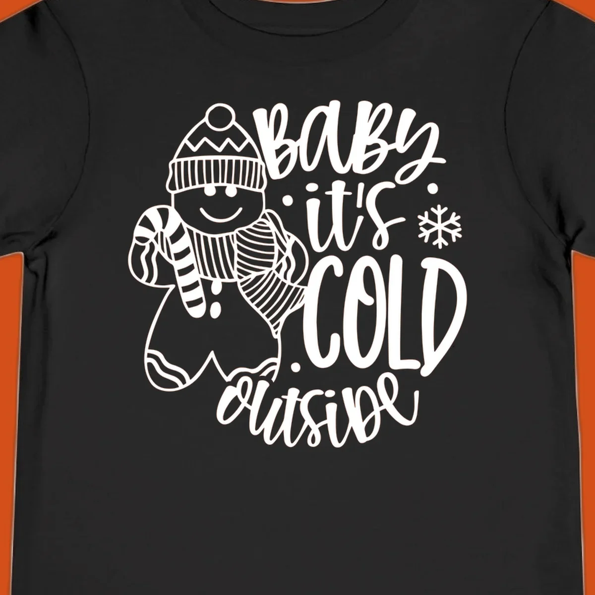 Baby it's cold outside gingerbread man with snowflake graphic.