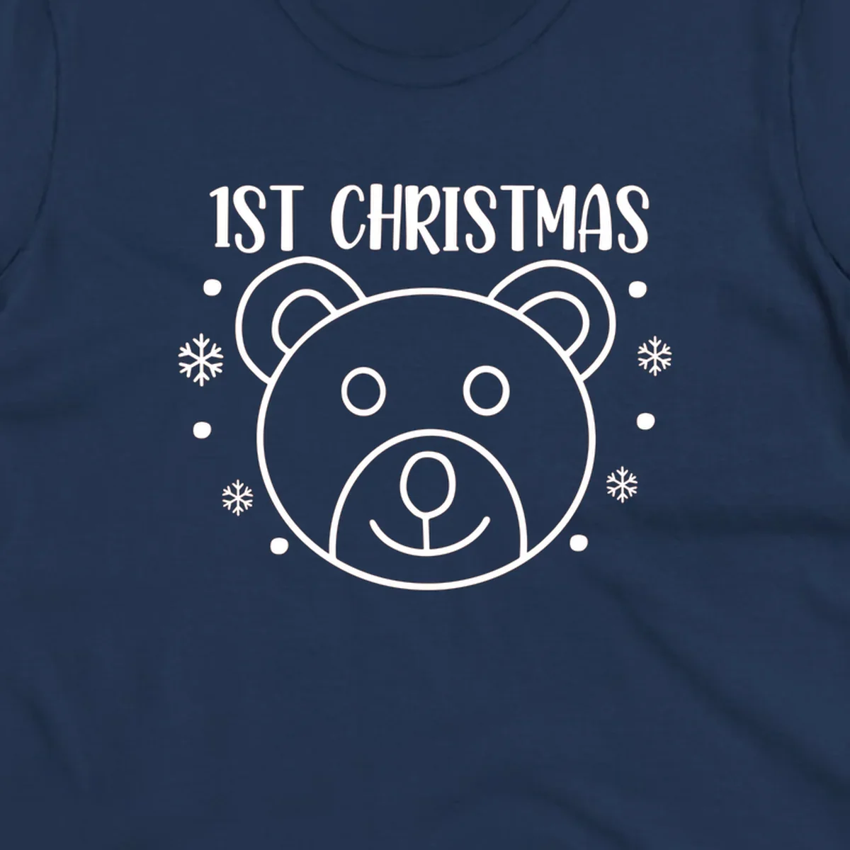 Baby's first christmas bear graphic with text and snowflakes.