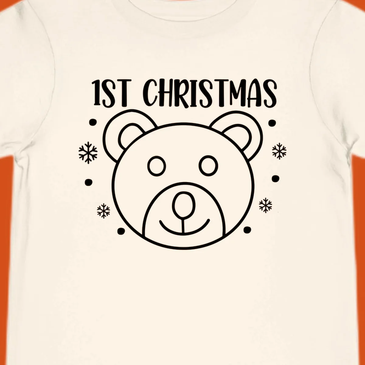 Baby's first christmas bear graphic with text and snowflakes.