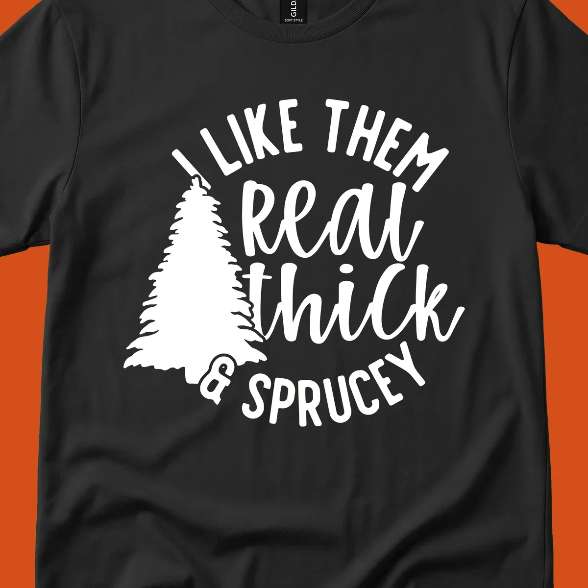 Illustration of a Christmas tree with text 'I like them real thick & sprucey', for thick-sprucey-christmas designs.