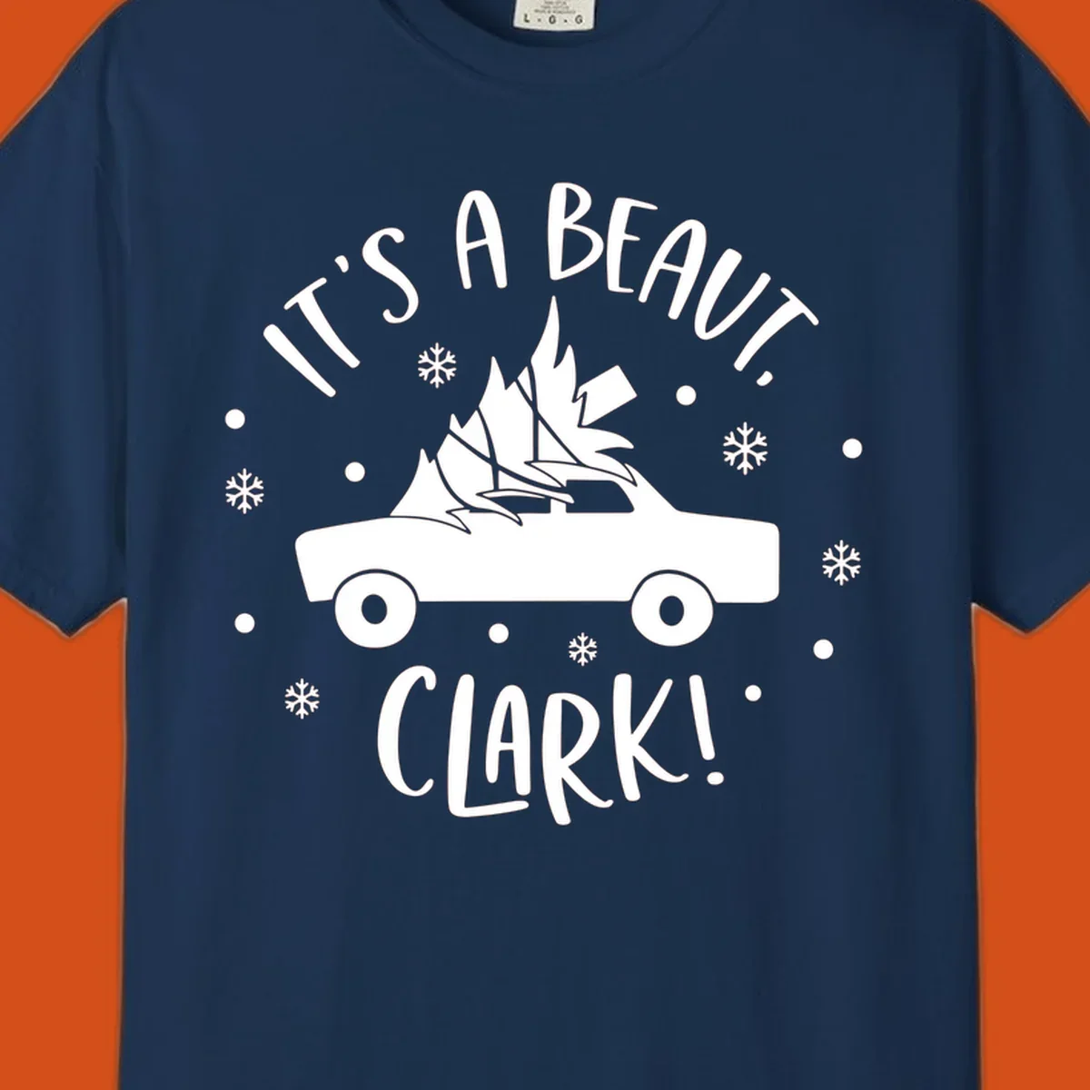 White silhouette of a car with a Christmas tree on top, and text 'IT'S A BEAUT, CLARK!'