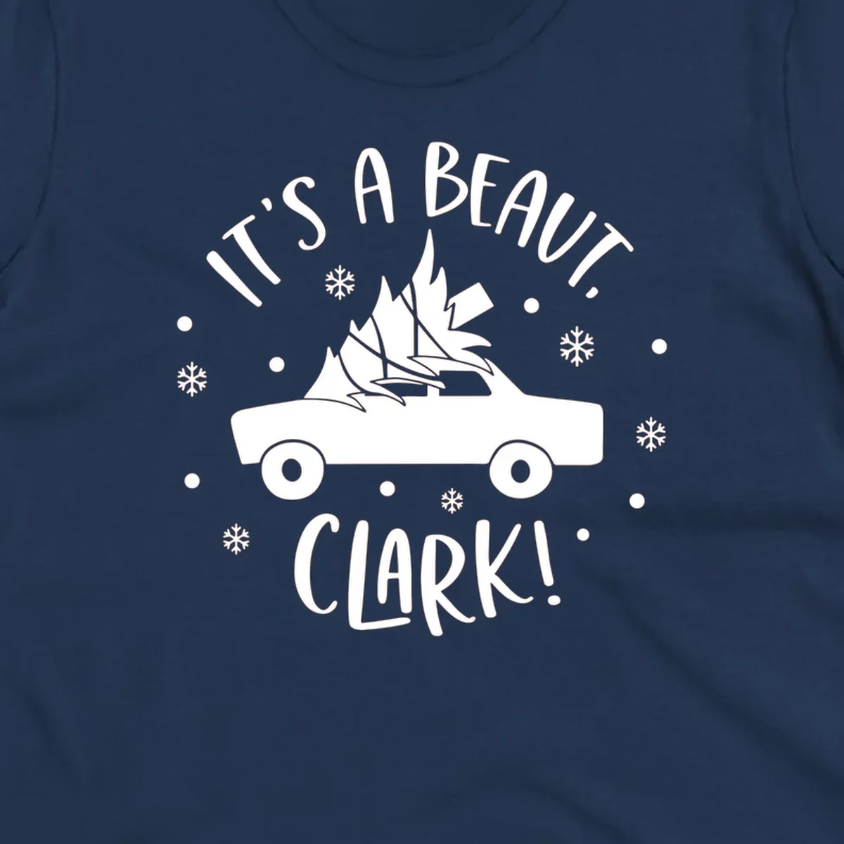 White silhouette of a car with a Christmas tree on top, and text 'IT'S A BEAUT, CLARK!'