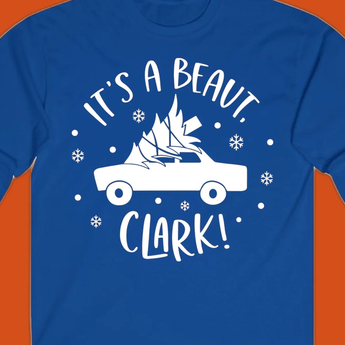 White silhouette of a car with a Christmas tree on top, and text 'IT'S A BEAUT, CLARK!'