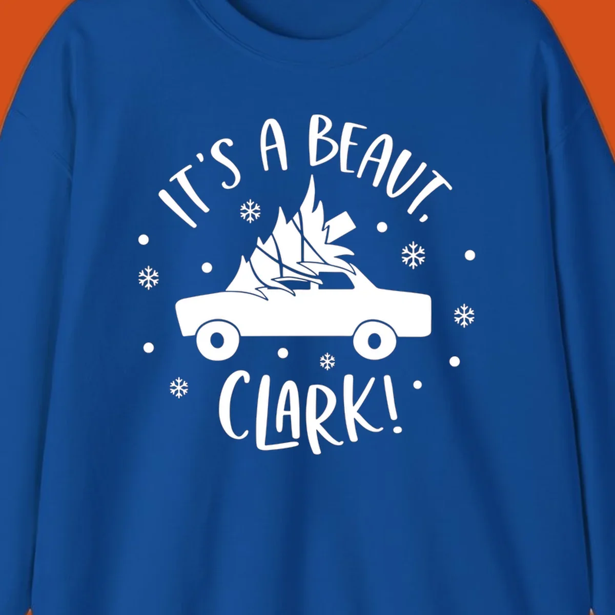 White silhouette of a car with a Christmas tree on top, and text 'IT'S A BEAUT, CLARK!'