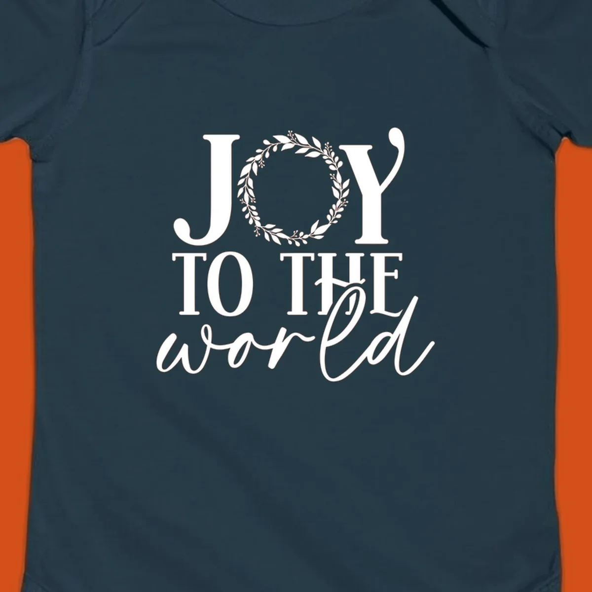 Joy to the World Christmas text design with a wreath replacing the letter O. White text on black background.