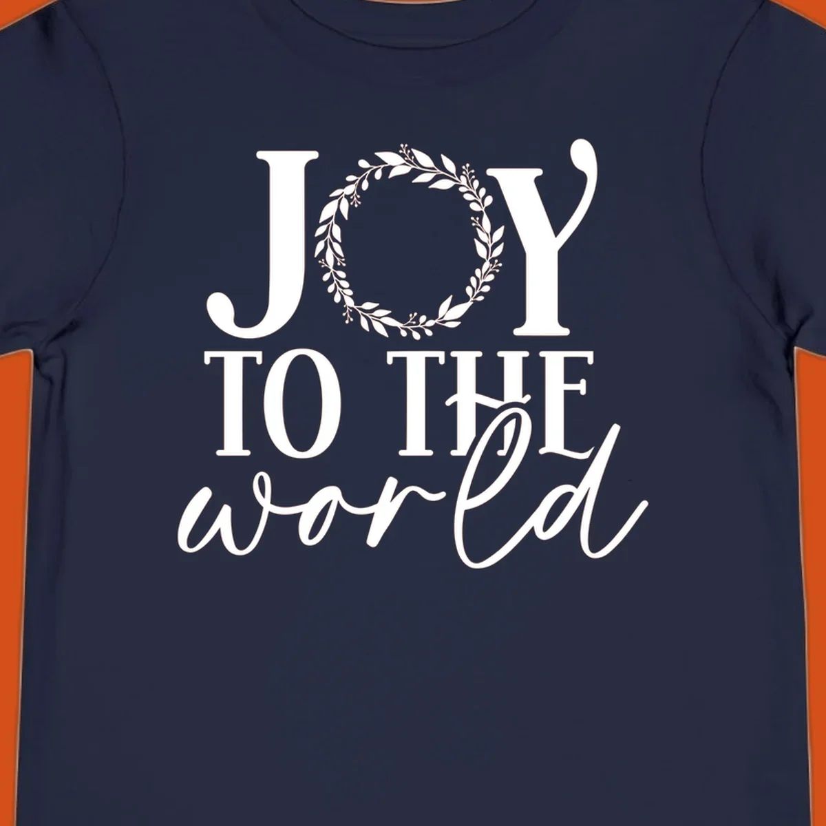 Joy to the World Christmas text design with a wreath replacing the letter O. White text on black background.