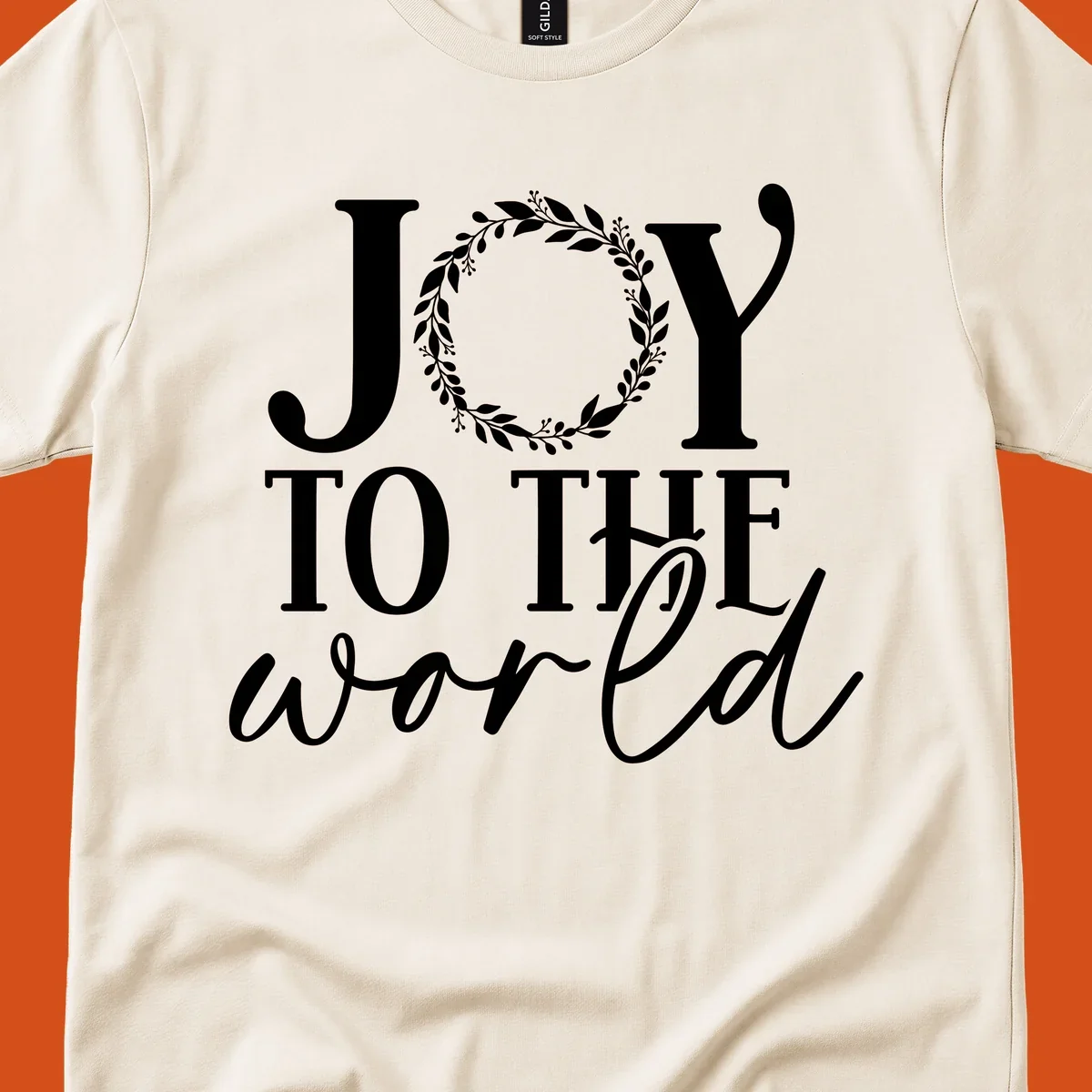 Joy to the World Christmas text design with a wreath replacing the letter O. White text on black background.