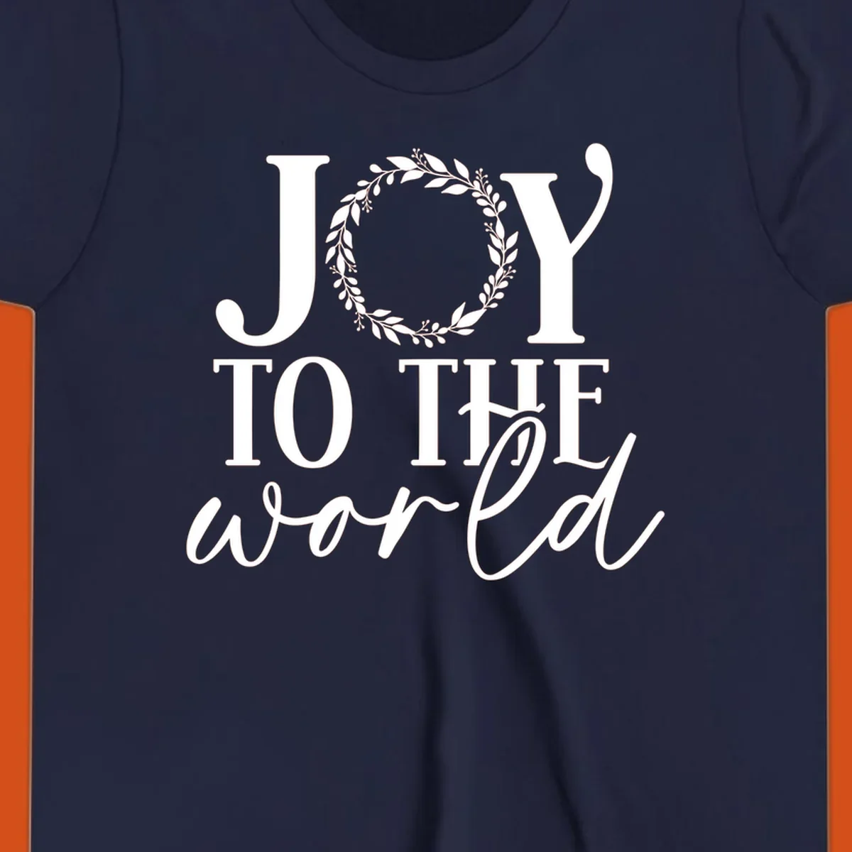Joy to the World Christmas text design with a wreath replacing the letter O. White text on black background.