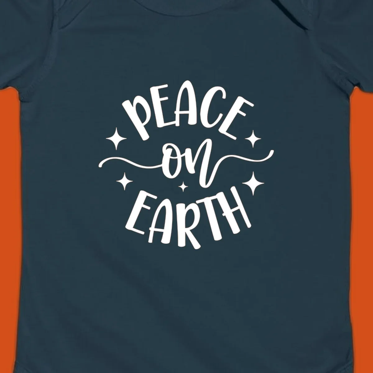 Peace on Earth holiday typography design with stars and swirls.