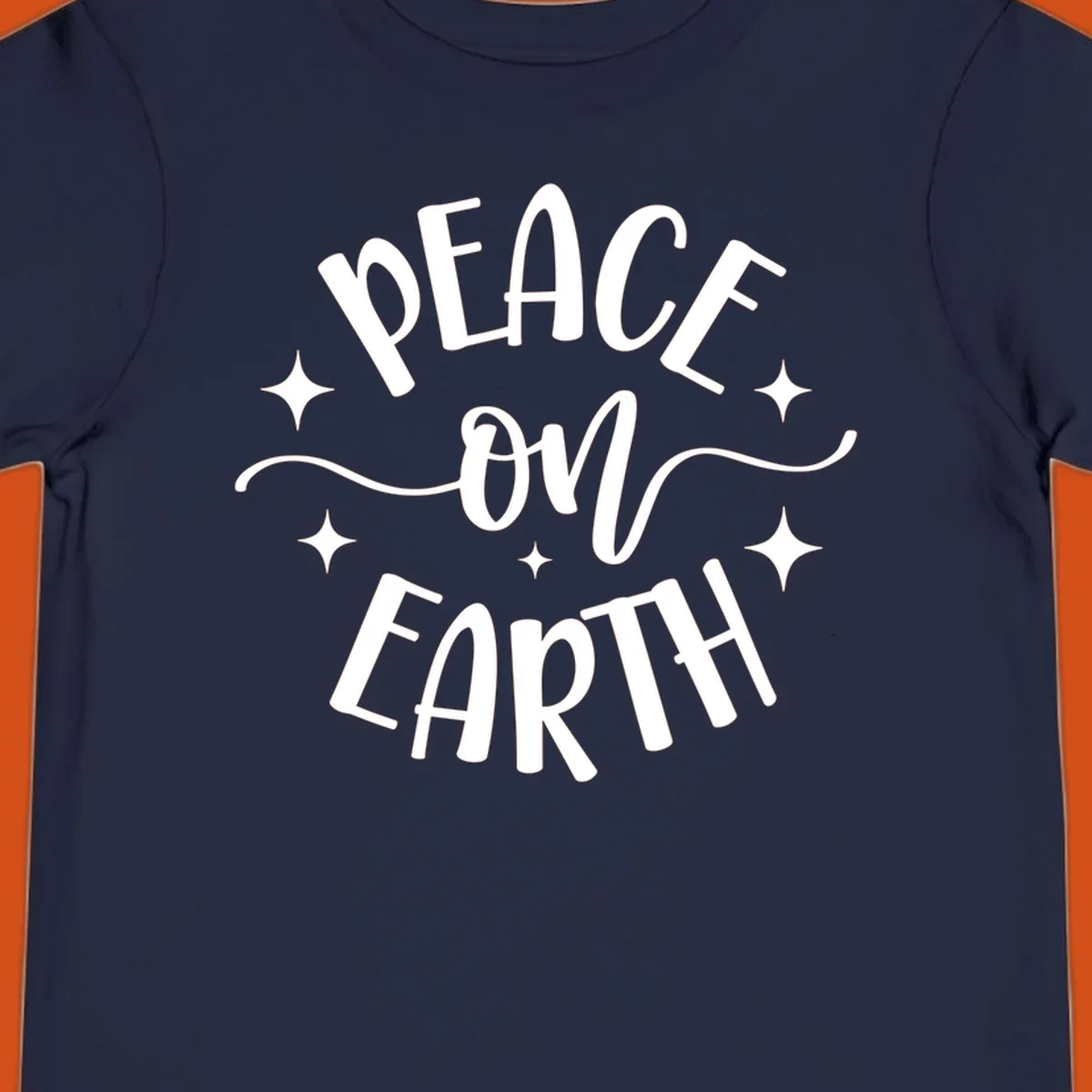 Peace on Earth holiday typography design with stars and swirls.