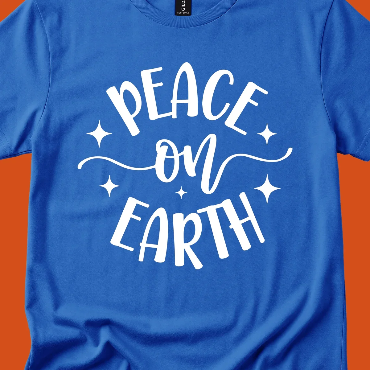 Peace on Earth holiday typography design with stars and swirls.