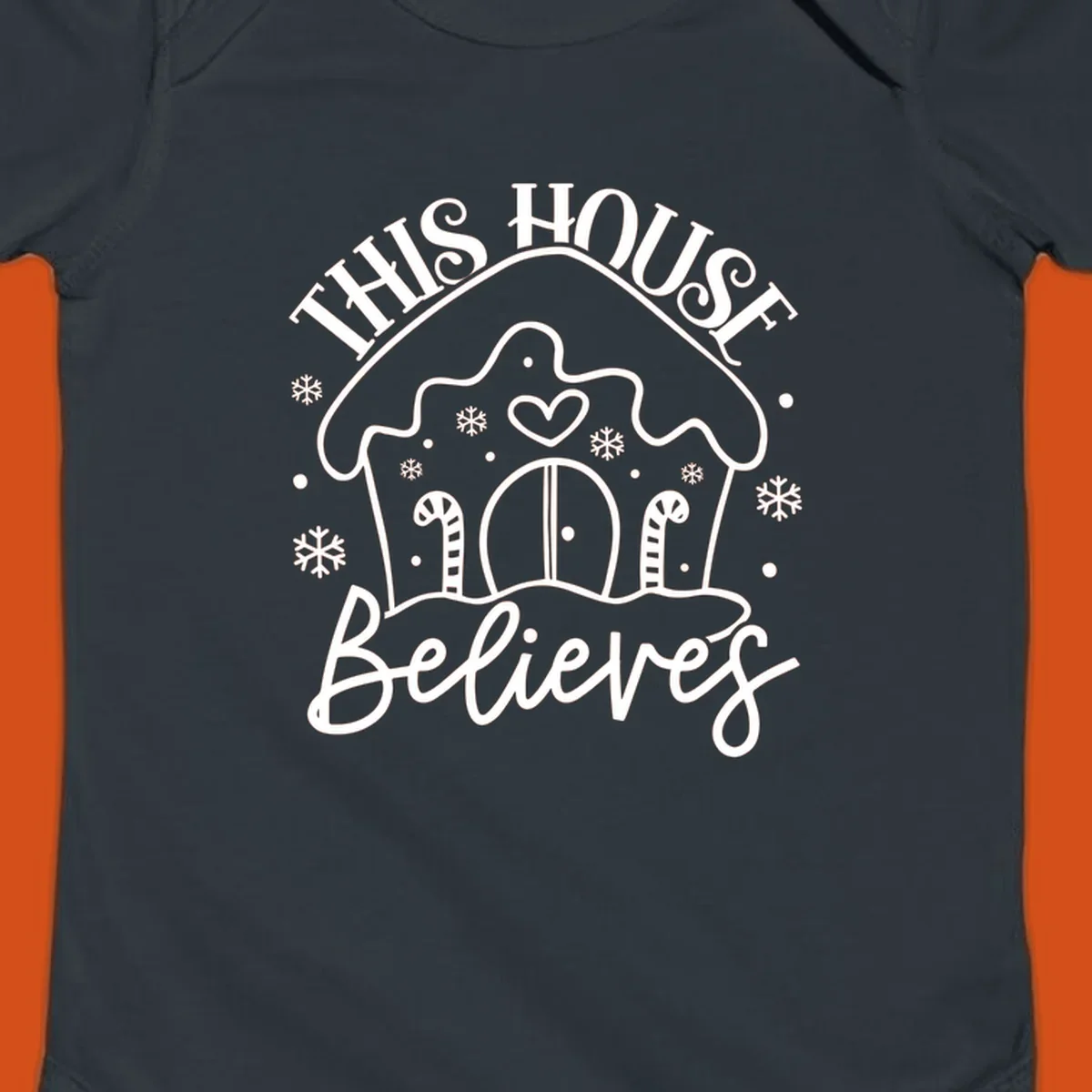 Gingerbread house graphic with 'This House Believes' text for Christmas.
