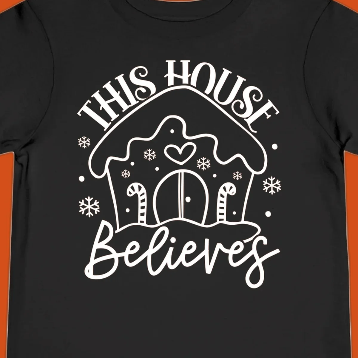 Gingerbread house graphic with 'This House Believes' text for Christmas.