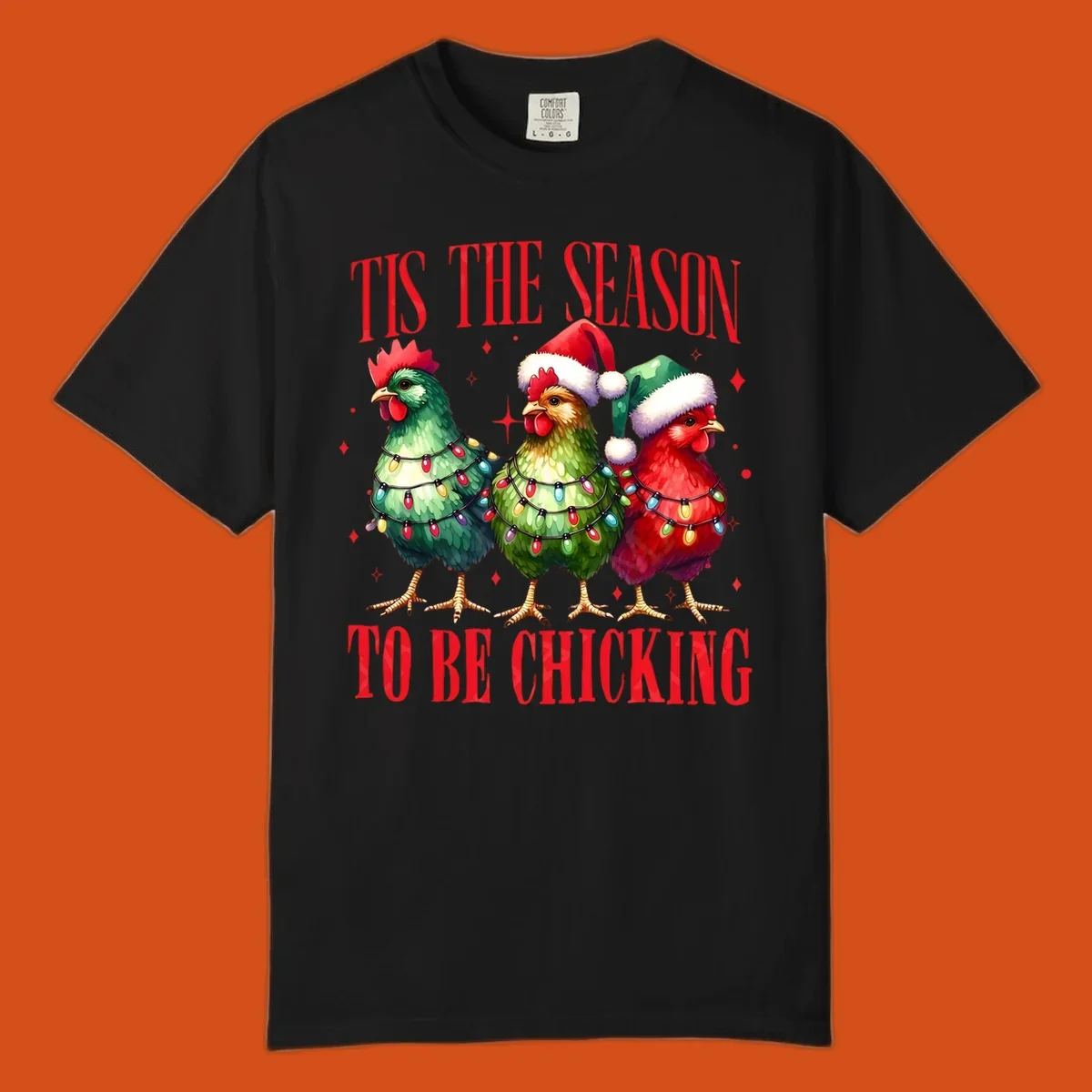 Christmas chickens wearing Santa hats and decorated with lights, with text 'Tis The Season To Be Chicking'.