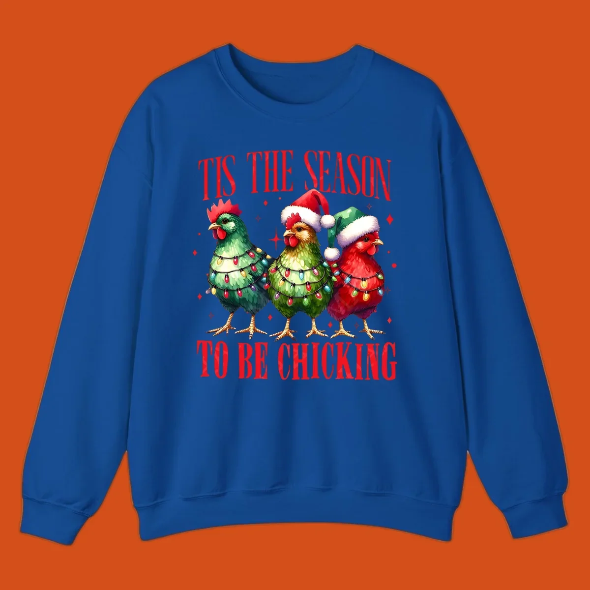 Christmas chickens wearing Santa hats and decorated with lights, with text 'Tis The Season To Be Chicking'.