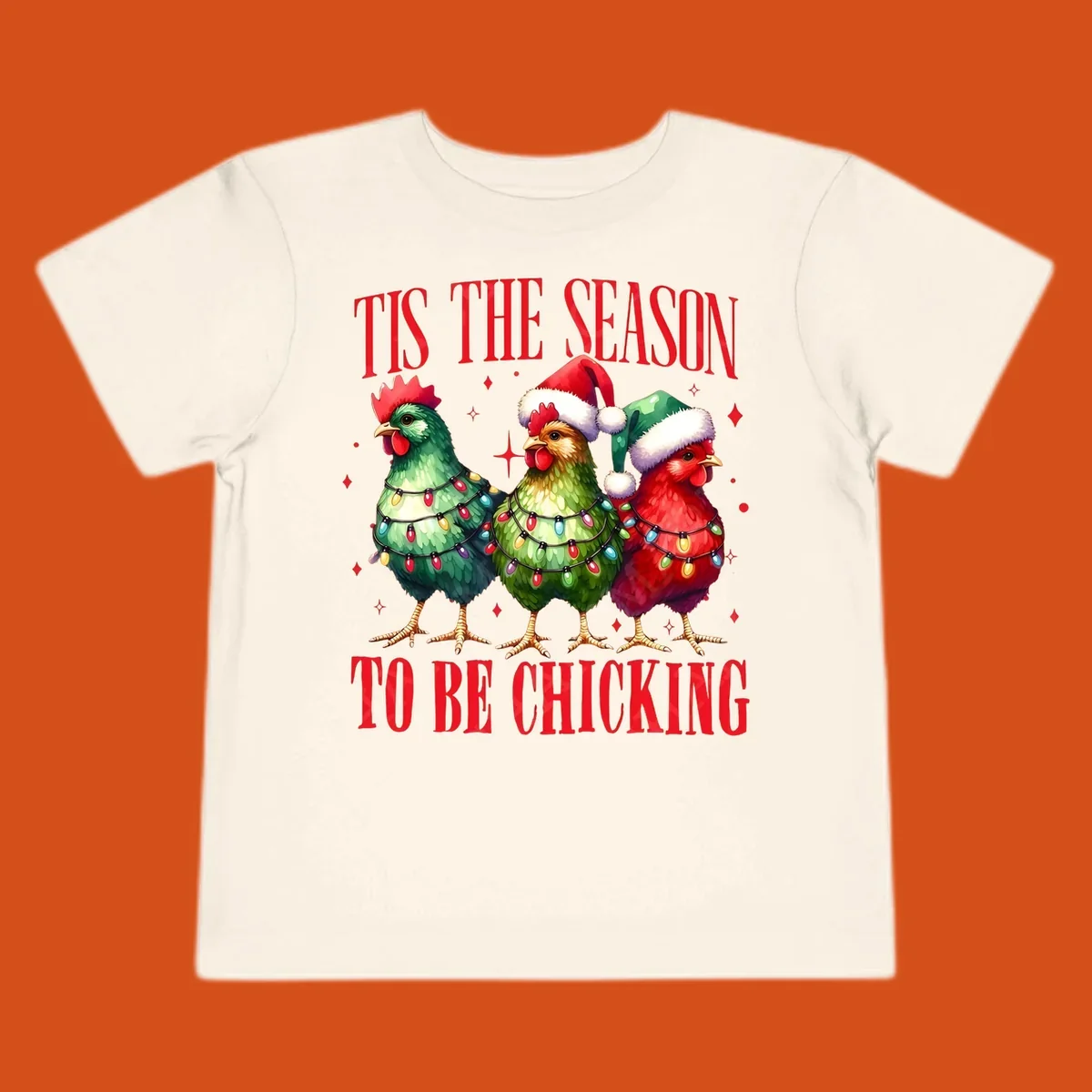 Christmas chickens wearing Santa hats and decorated with lights, with text 'Tis The Season To Be Chicking'.