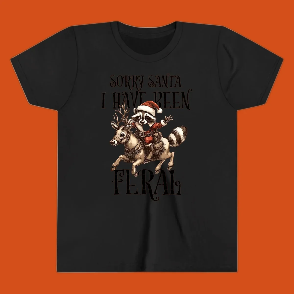 Feral raccoon in Santa hat riding reindeer, with text sorry santa i have been feral.