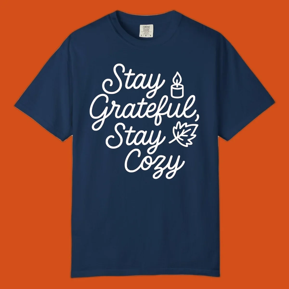 Text design with 'Stay Grateful, Stay Cozy' phrase, candle, and leaf for grateful-cozy-fall theme.