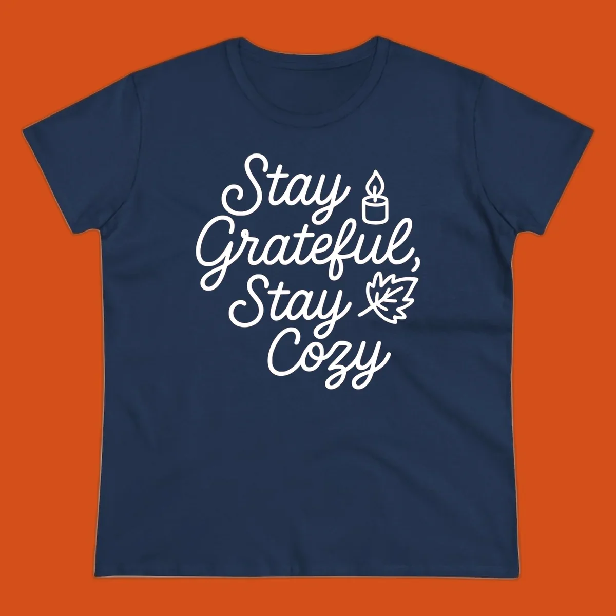 Text design with 'Stay Grateful, Stay Cozy' phrase, candle, and leaf for grateful-cozy-fall theme.