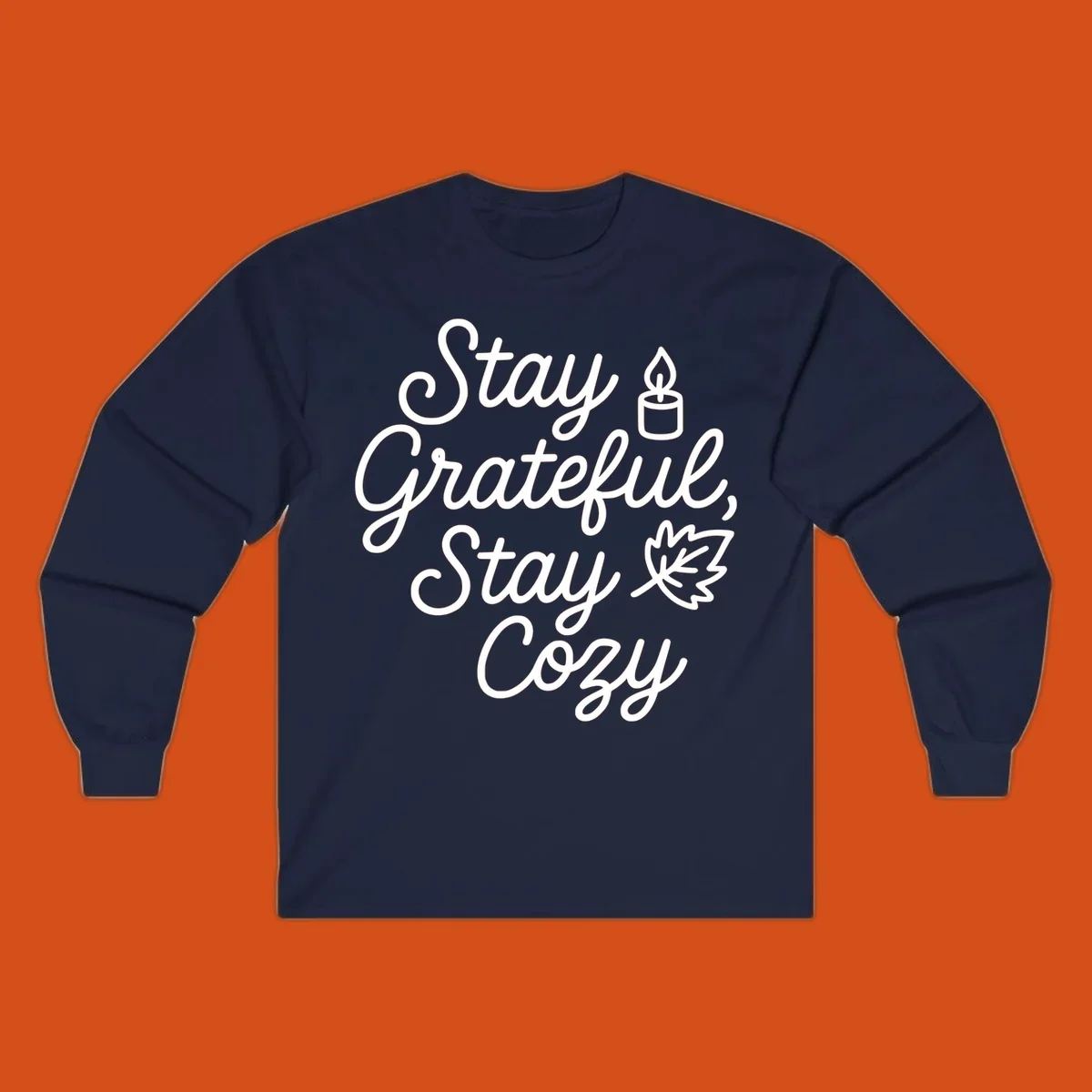 Text design with 'Stay Grateful, Stay Cozy' phrase, candle, and leaf for grateful-cozy-fall theme.