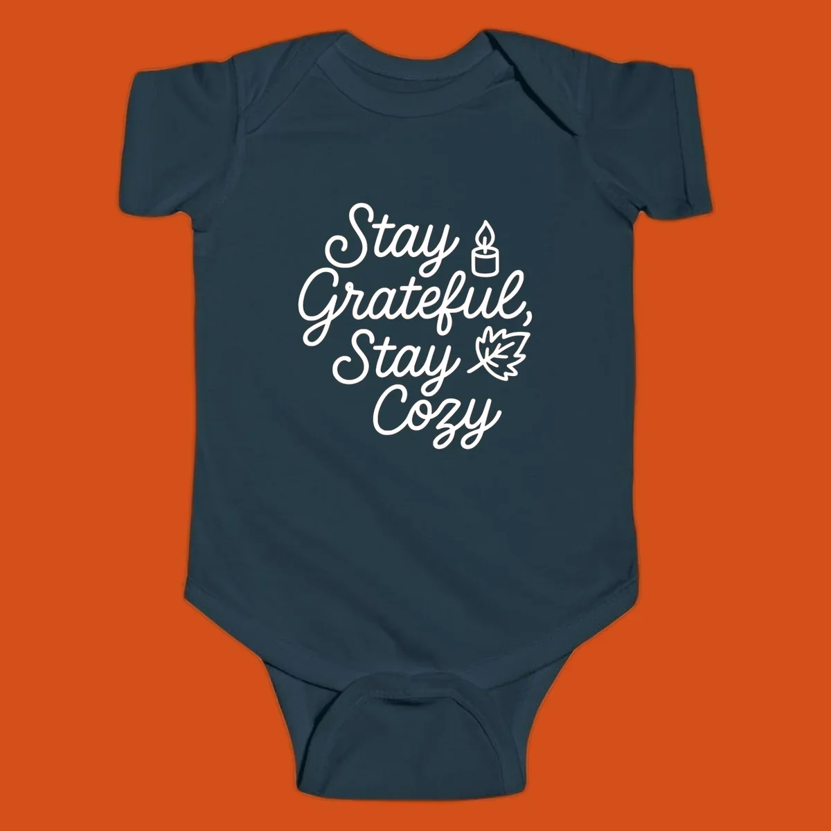 Text design with 'Stay Grateful, Stay Cozy' phrase, candle, and leaf for grateful-cozy-fall theme.