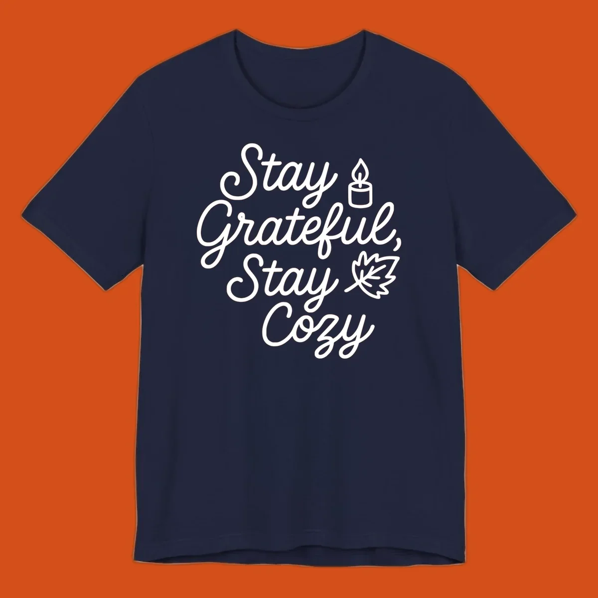 Text design with 'Stay Grateful, Stay Cozy' phrase, candle, and leaf for grateful-cozy-fall theme.