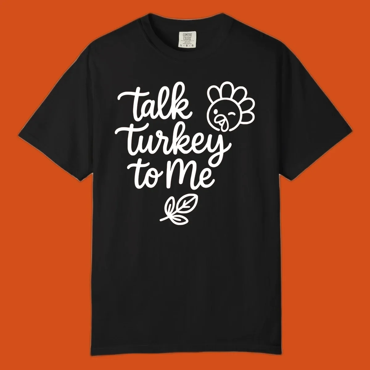 Talk Turkey To Me Thanksgiving phrase with cartoon turkey and leaf illustration.