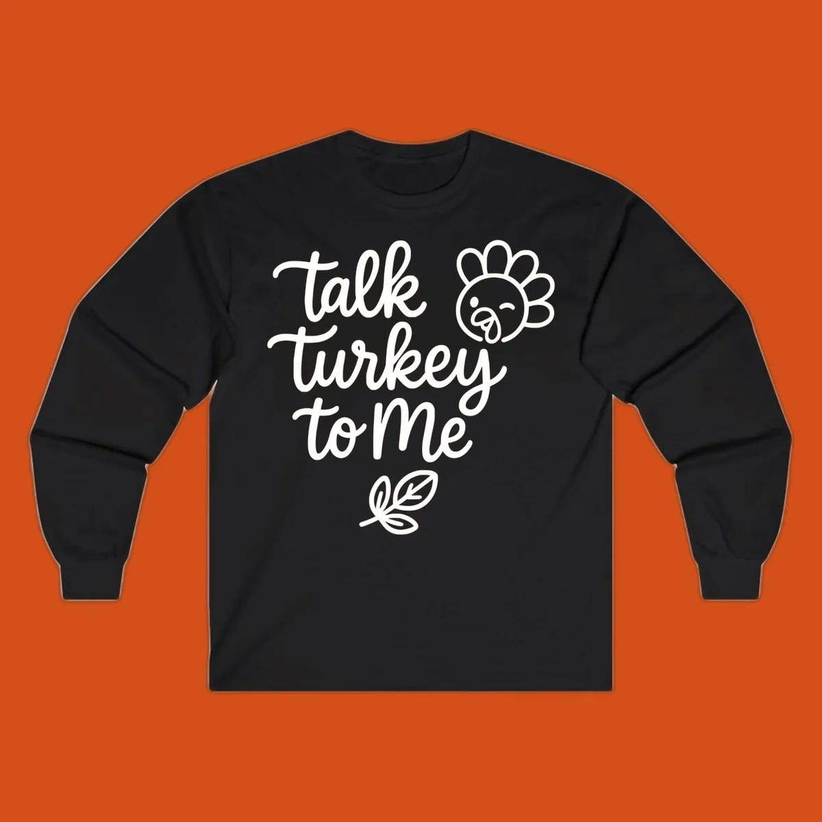 Talk Turkey To Me Thanksgiving phrase with cartoon turkey and leaf illustration.