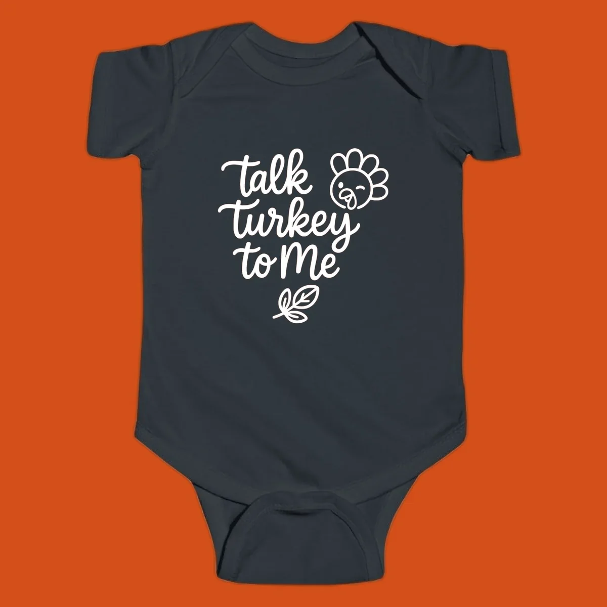 Talk Turkey To Me Thanksgiving phrase with cartoon turkey and leaf illustration.
