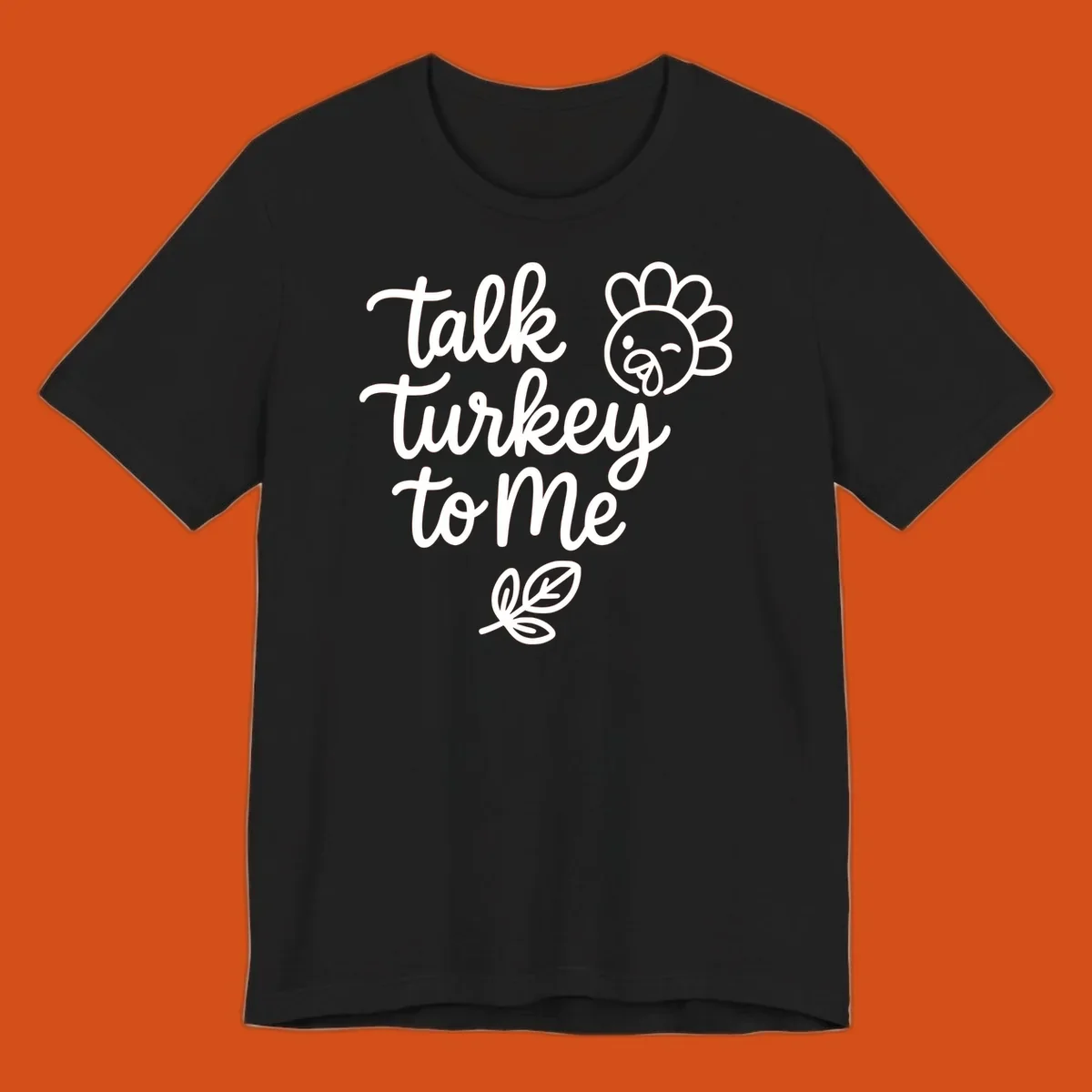 Talk Turkey To Me Thanksgiving phrase with cartoon turkey and leaf illustration.