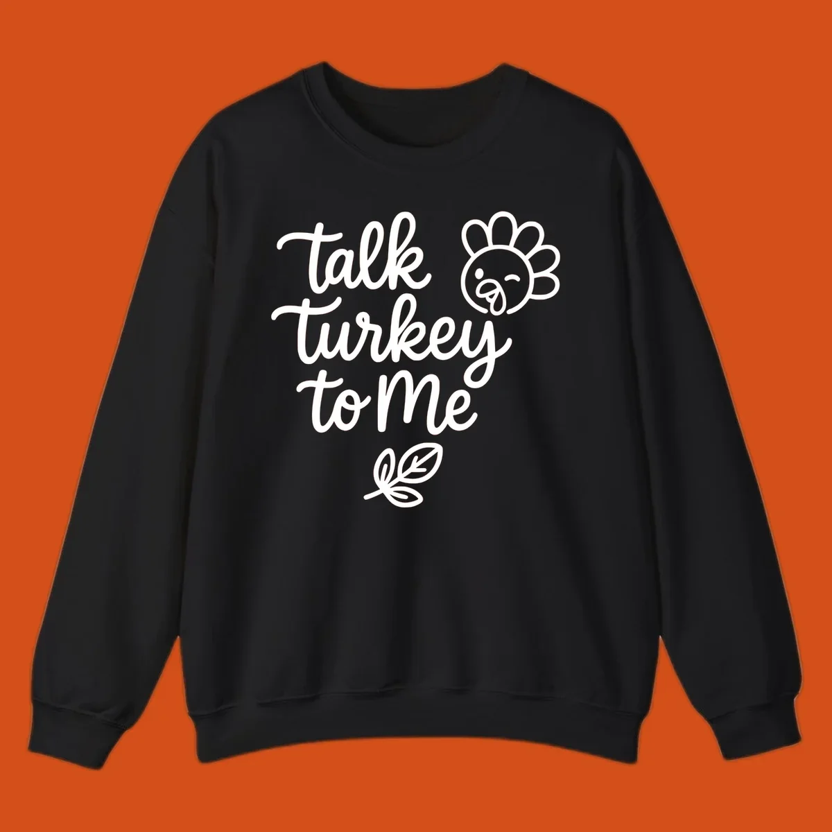 Talk Turkey To Me Thanksgiving phrase with cartoon turkey and leaf illustration.