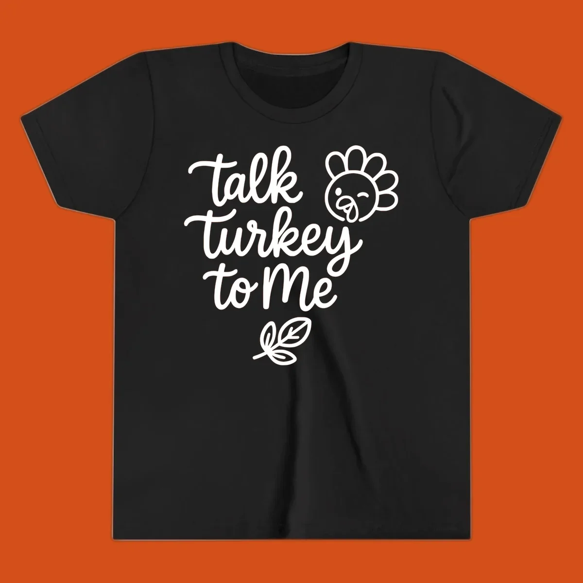 Talk Turkey To Me Thanksgiving phrase with cartoon turkey and leaf illustration.