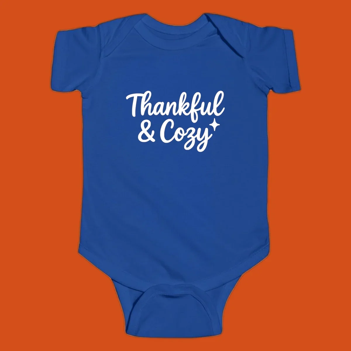 Thankful and cozy script text with starburst design.