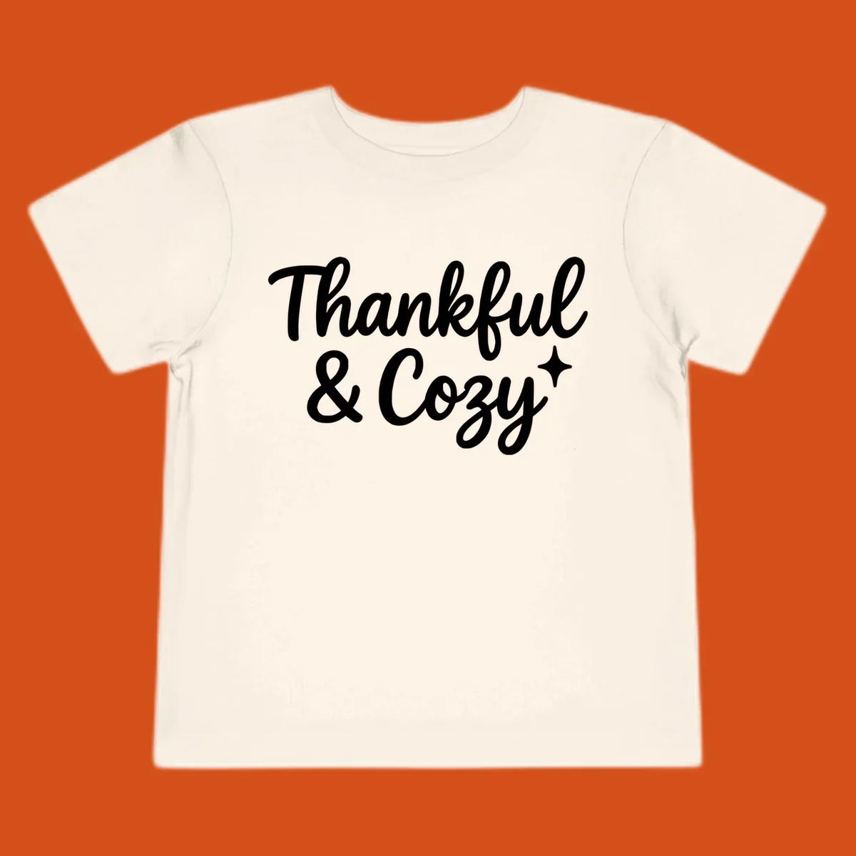 Thankful and cozy script text with starburst design.