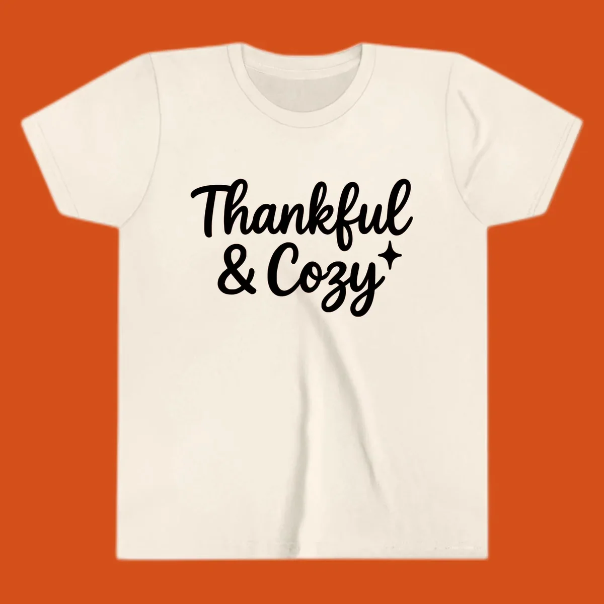 Thankful and cozy script text with starburst design.
