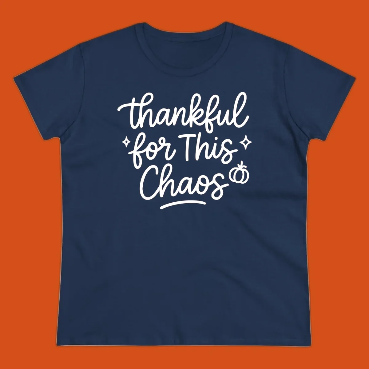 White script text 'thankful for This Chaos' with sparkles and a pumpkin on a black background.